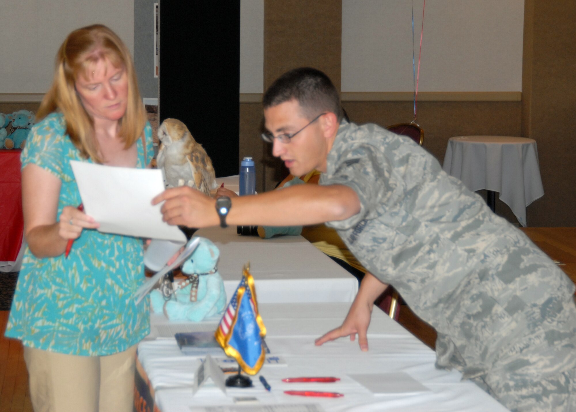 Senior Airman Anthony Particini, 95th Aerospace Medical Squadron bioenvironmental engineer, talks to fair participants about volunteer opportunities on Edwards during the Volunteer Fair at Club Muroc on Sept.11. Volunteer fairs are designed to show base personnel what volunteer options they have. (Air Force photo by Airman 1st Class William O’Brien)