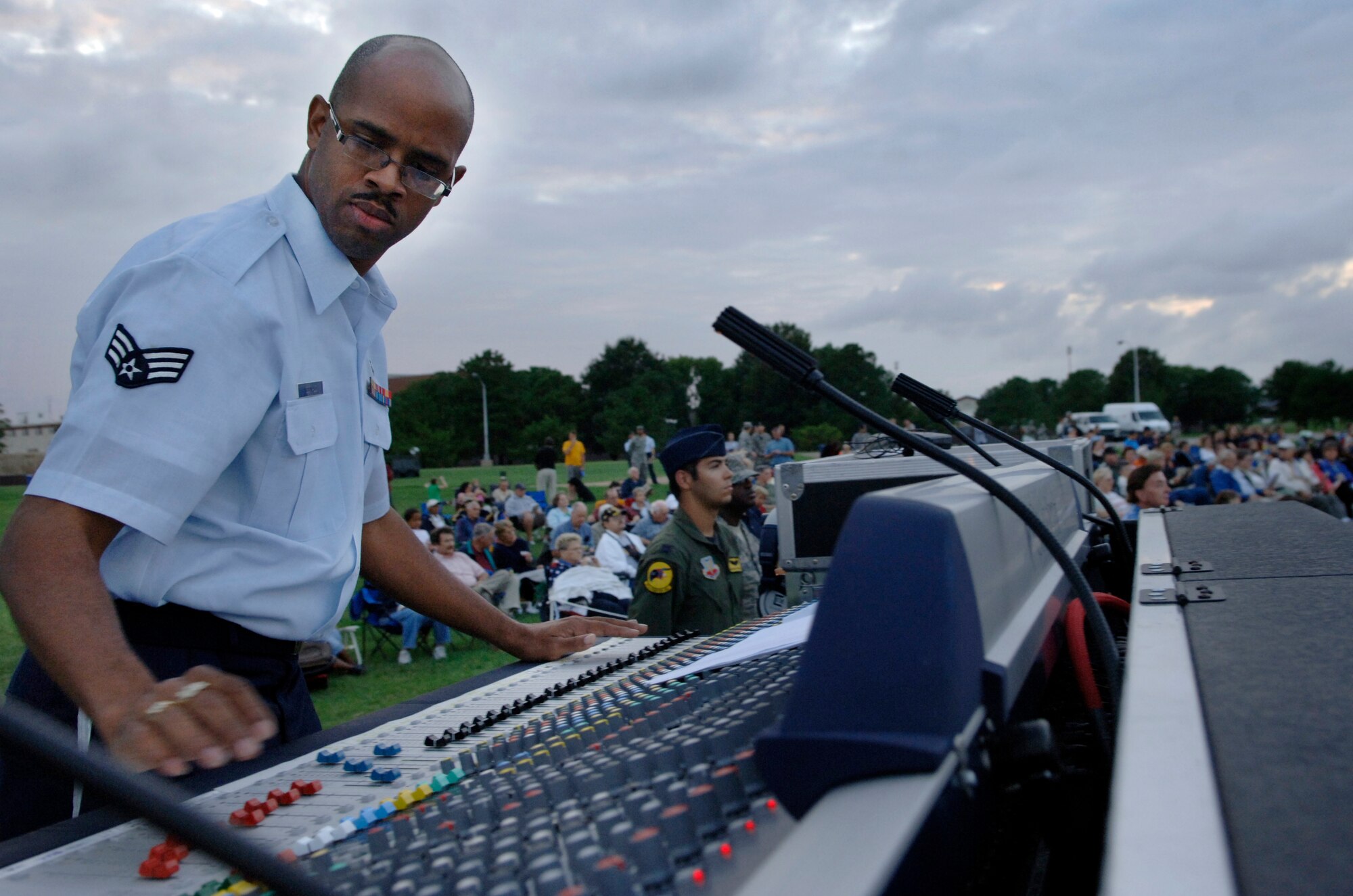 LANGLEY AIR FORCE BASE, Va. -- Senior Airman Kelcey McDonald, Air Combat Command Heritage of America Band sound technician, operates the sound board during the ACC Tattoo ceremony at Memorial Park Sept. 11.  The ACC Tattoo tribute is a 75-minute production that honors America's Airmen, both past and present.  (U.S. Air Force photo/Senior Airman Vernon Young)