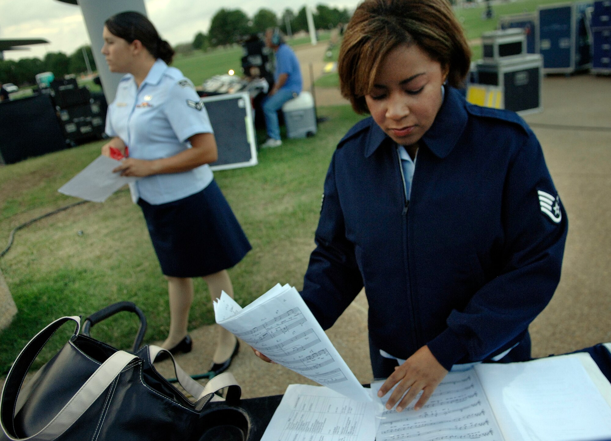 LANGLEY AIR FORCE BASE, Va. -- Staff Sgt. Natalie Madison, Air Combat Command Heritage of America Band vocalist, sorts through music before the ACC Tattoo ceremony on Sept. 11.  The ACC Tattoo tribute is a 75-minute production that honors America's Airmen, both past and present.  (U.S. Air Force photo/Senior Airman Vernon Young)