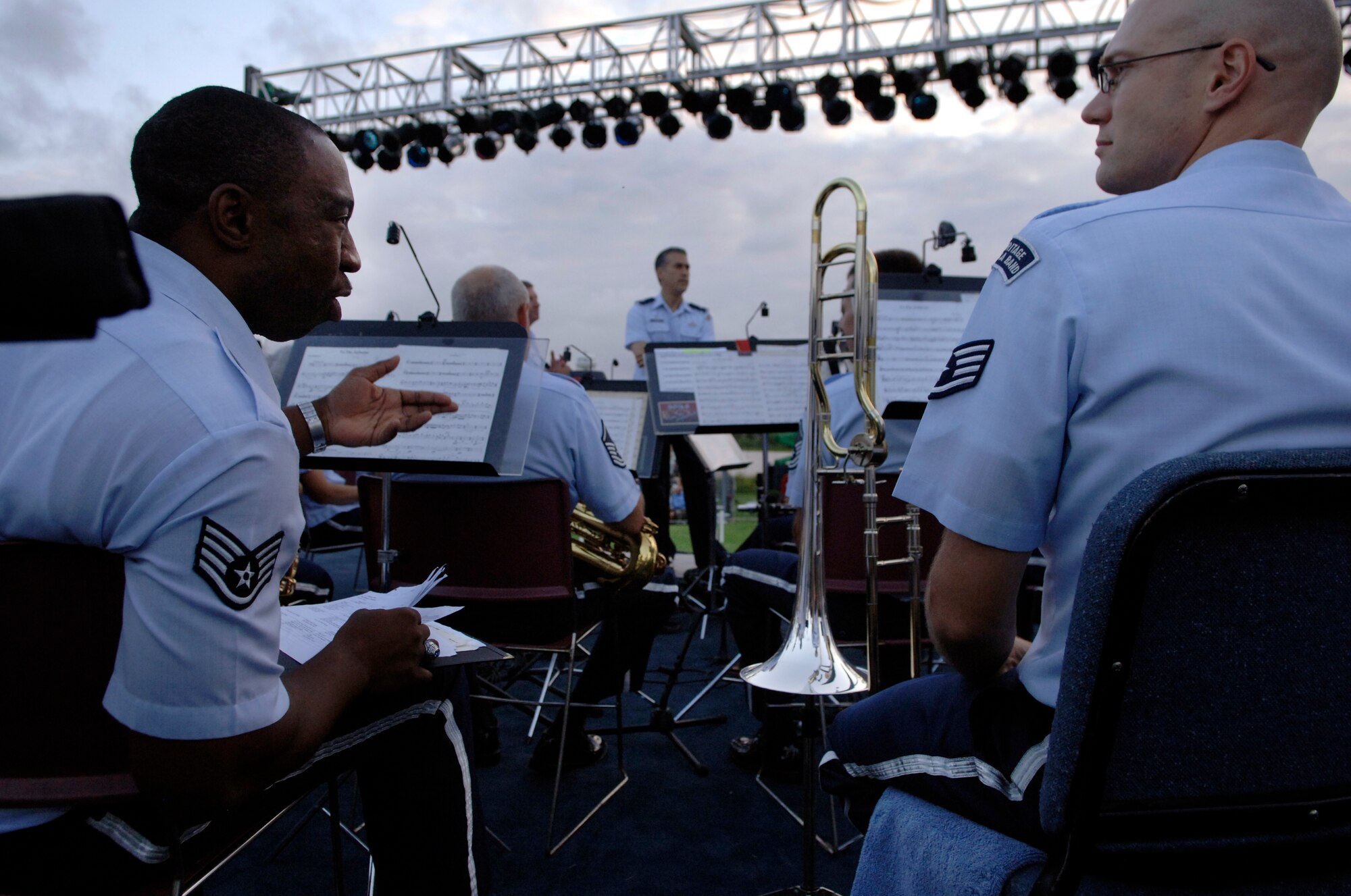 LANGLEY AIR FORCE BASE, Va. -- Airmen of the Air Combat Command Heritage of America Band speak about musical notes during the ACC Tattoo ceremony Sept. 11.  The ACC Heritage of America Band performs annually to support the ceremony.   The ACC Tattoo tribute is a 75-minute production that honors America's Airmen, both past and present.  (U.S. Air Force photo/Senior Airman Vernon Young)