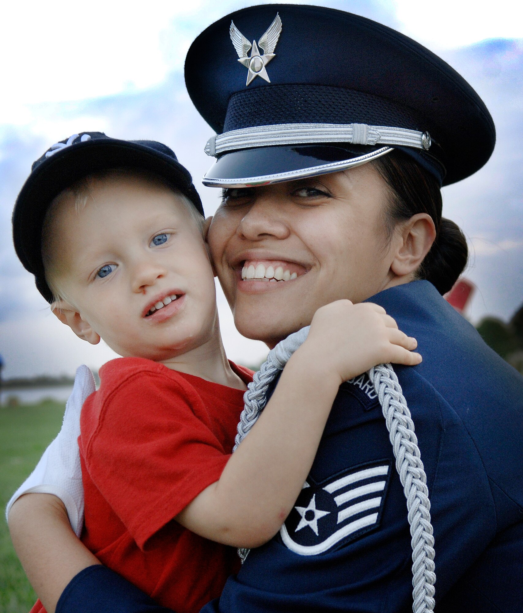 LANGLEY AIR FORCE BASE, Va. -- Owen Lennon, grandson of retired Lt. Col. Kenneth Wissinger, hugs Staff Sgt. Keisha Labowski-Ferris, 1st Mission Support Squadron, before the Air Combat Command Tattoo ceremony Sept. 11.   The ACC Tattoo tribute is a 75-minute production that honors America's Airmen, both past and present.  (U.S. Air Force photo/Senior Airman Vernon Young)