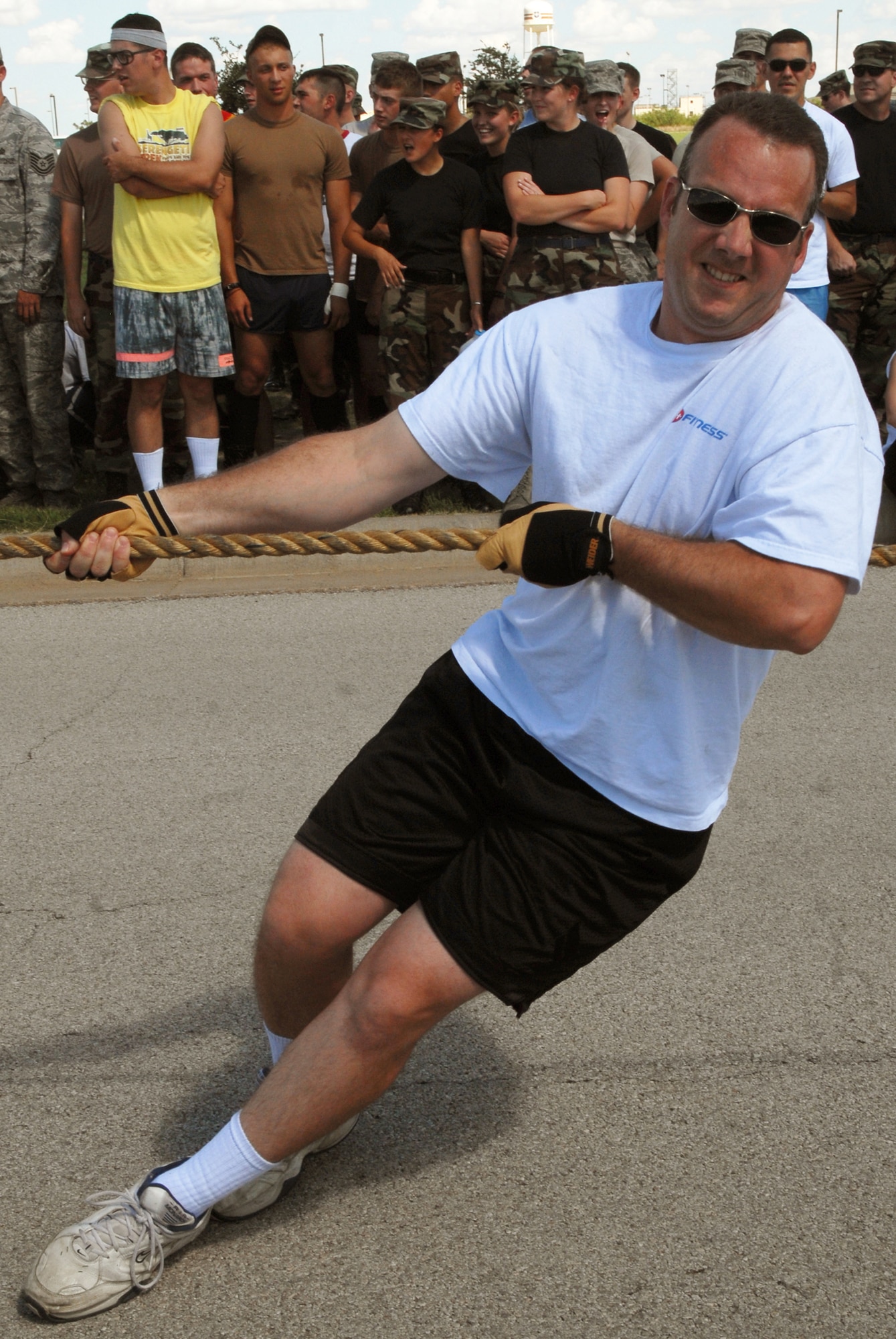 Technical Sergeant Thomas Hamilton, 17th Training Wing Judge Advocate General's office paralegal, works to help the 17th Training Wing staff team pull a 14.5 ton fire truck 100 feet during a Combined Federal Campaign fundraiser on Goodfellow Air Force Base Sept. 5. A total of 31 teams competed in the event. (U.S. Air Force photo by Senior Airman Kasabyan Musal)