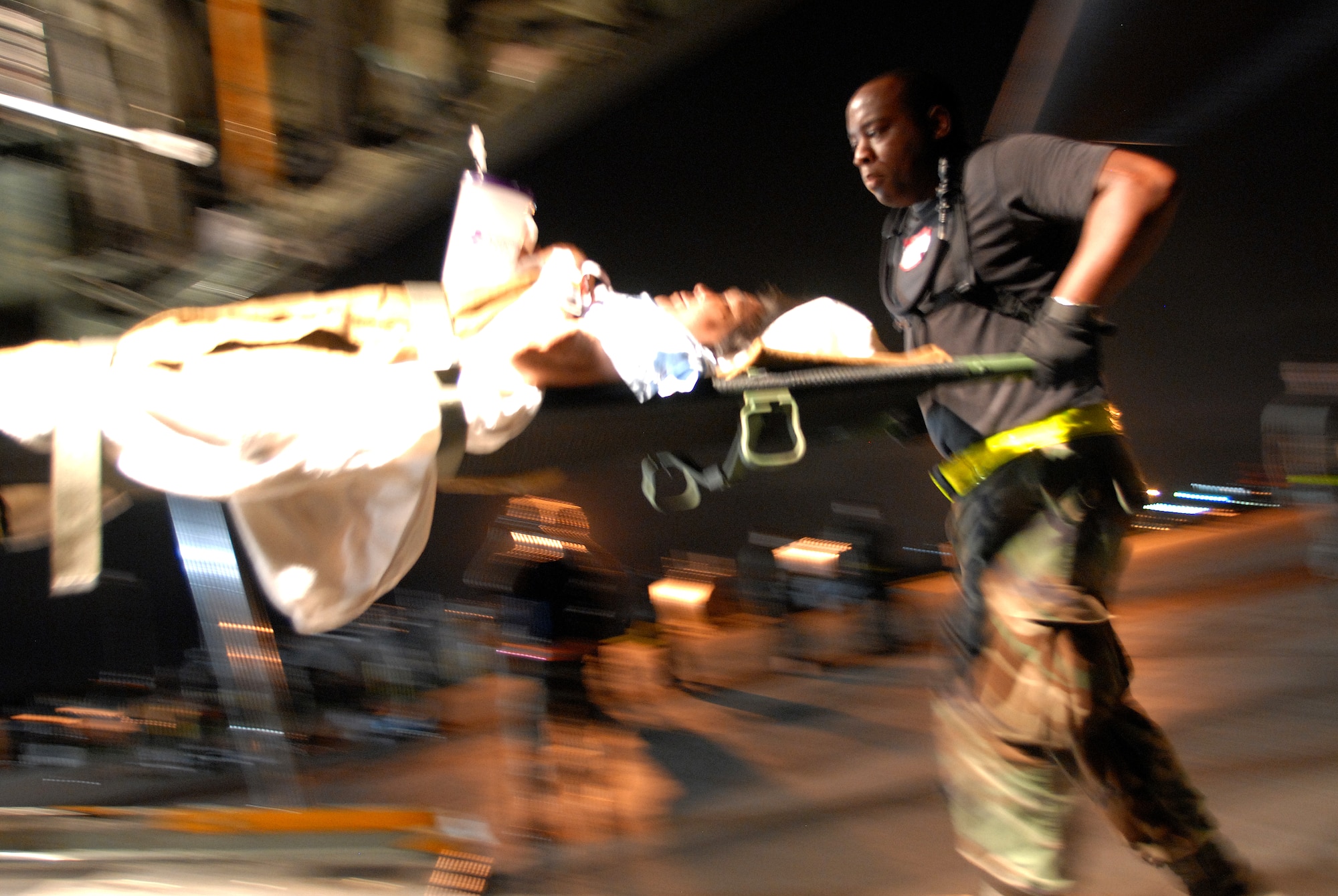 CORPUS CHRISTI INTERNATIONAL AIRPORT, Texas -- Senior Airman Kenneth Alexander, 6th Medical Group medical technician, loads a patient onto a C-130E aircraft, September 11, 2008. U.S. Air Force C-130 aircraft and crews are tasked routinely to evacuate possible natural disaster victims to safer locations. (U.S. Air Force photo by Airman 1st Class Steele Briton) (RELEASED)