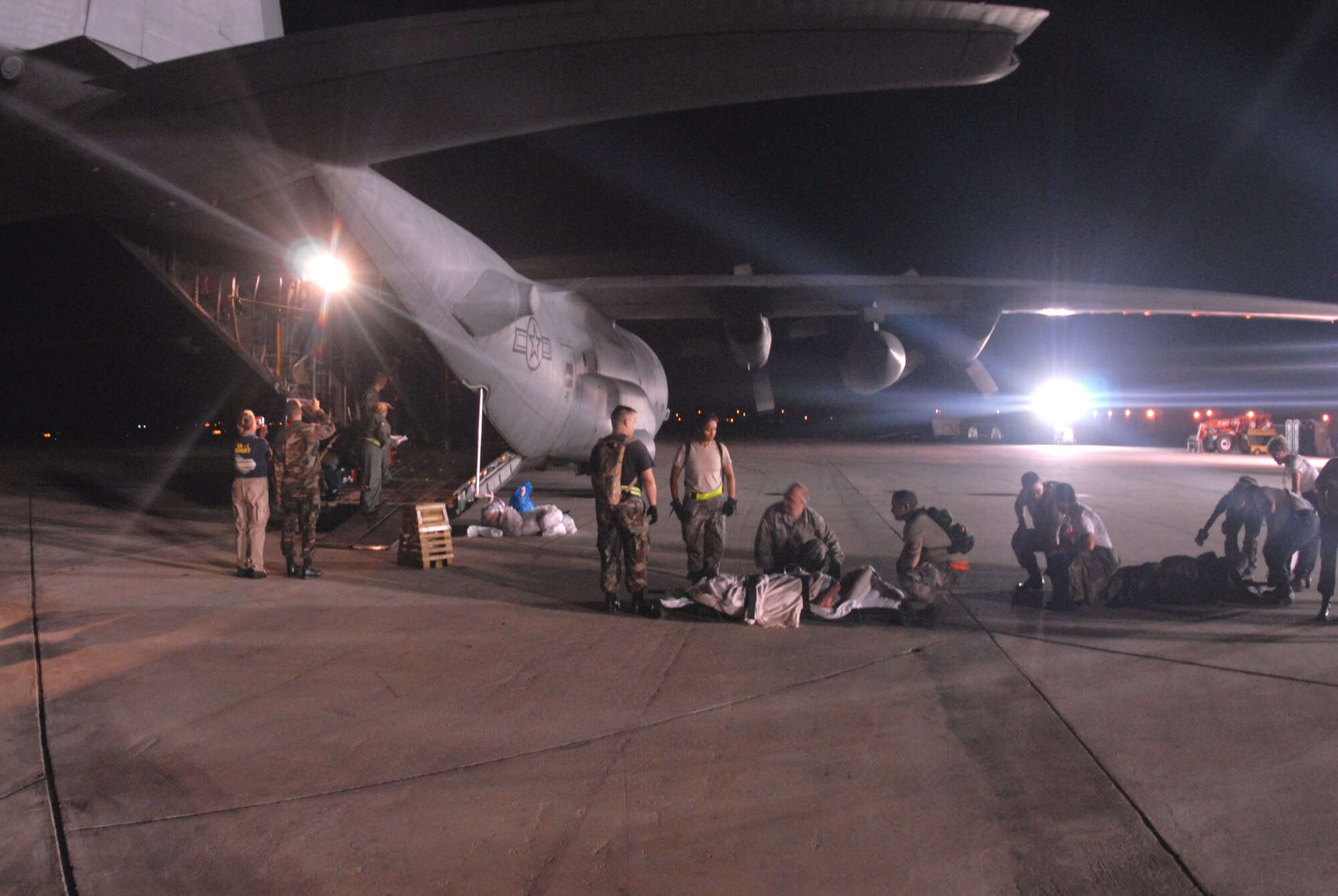 CORPUS CHRISTI INTERNATIONAL AIRPORT, Texas -- U.S. Air Force Airmen prepare to load hospital patients on to a C-130E aircraft, September 11, 2008. Little Rock Air Force Base C-130 aircraft and crews are tasked routinely to evacuate possible natural disaster victims to safer locations. (U.S. Air Force photo by Airman 1st Class Steele Briton) (RELEASED)