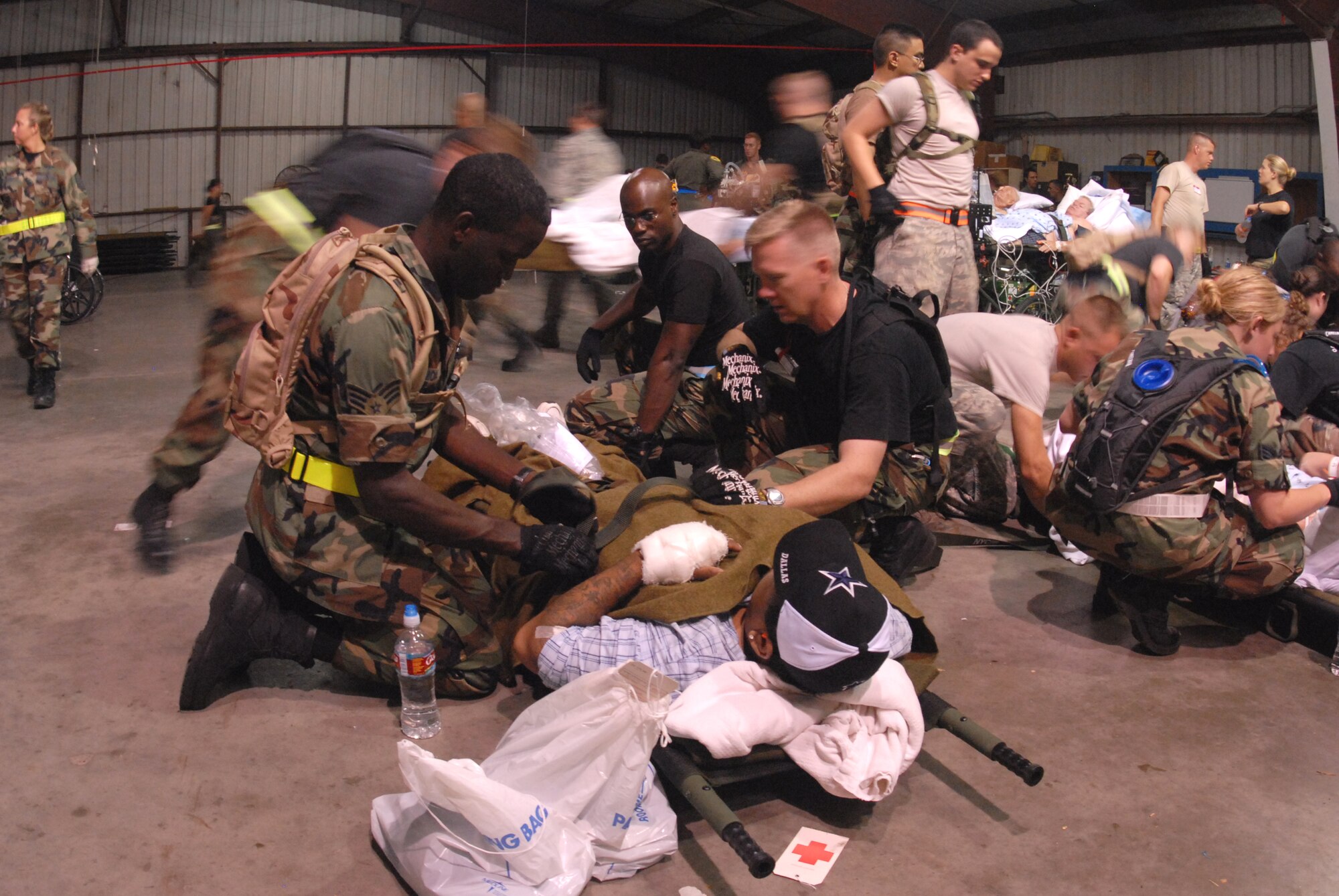 CORPUS CHRISTI INTERNATIONAL AIRPORT, Texas -- U.S. Air Force Airmen attend to a patient, September 11, 2008. Military members are tasked routinely to evacuate possible natural disaster victims to safer locations. (U.S. Air Force photo by Airman 1st Class Steele Britton) (RELEASED) 