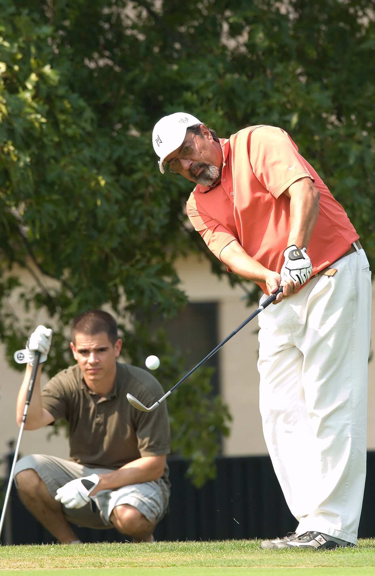 Jaime Rivera, Delaware Division of Public Health director and 512th Aerospace Medicine Squadron honorary commander, chips onto a green during the Bluesuiters Golf Tournament on base Sept. 4. The annual event features community members and Dover Team members coming together for a day of fun and camaraderie. Mr. Rivera played golf with Senior Airman Brendan Proctor (left), 3rd Airlift Squadron, Senior Airman Mike Irish, 9th AS, and Lt. Col. Thad Bibb, 9th AS. (U.S. Air Force photo/Jason Minto)
