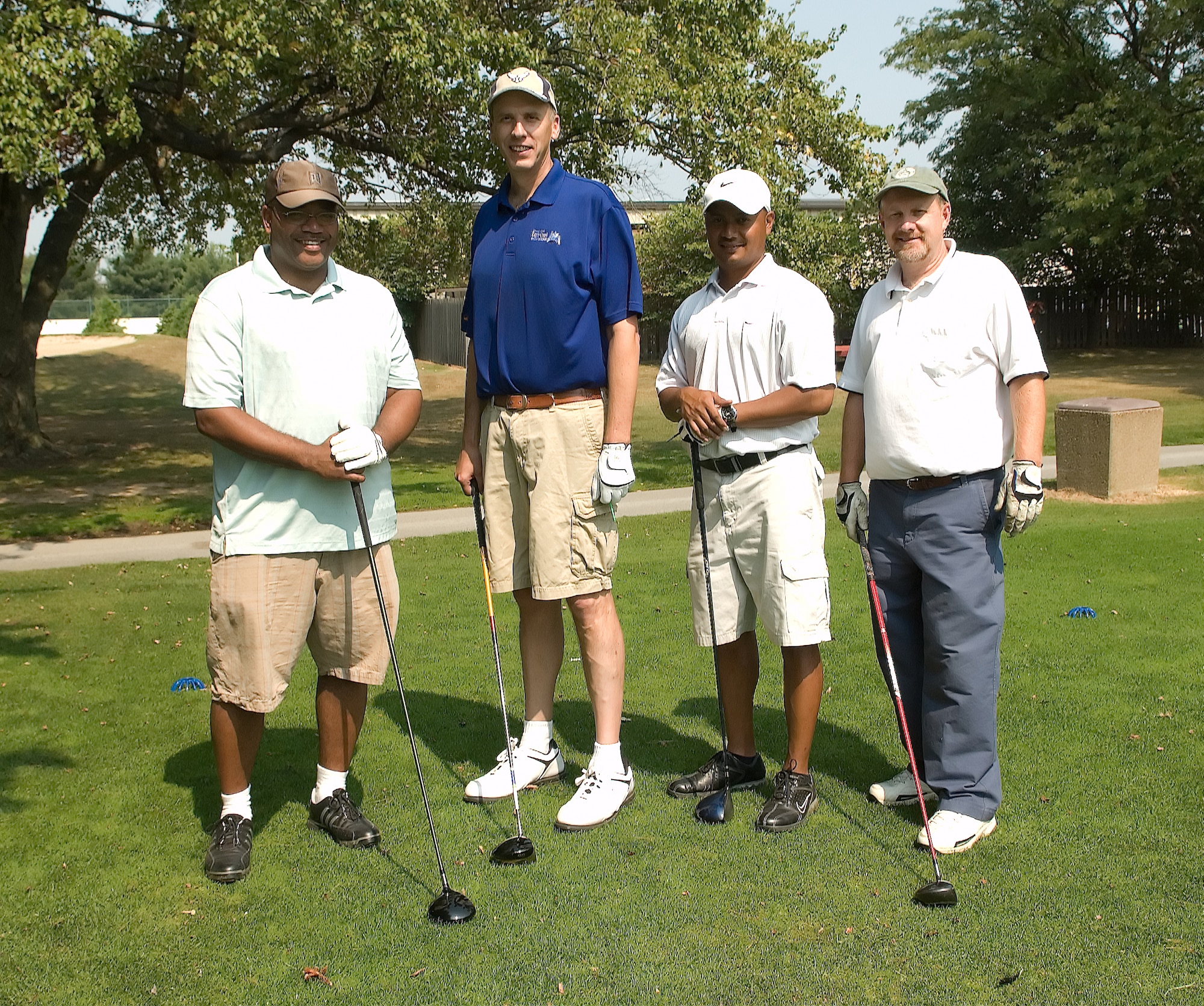 A team from the Bluesuiters Golf Tournament on base Sept. 4 stands ready to make their next drive. The annual event features community members and Dover Team members coming together for a day of fun and camaraderie. This team finished five under par. They are Tech. Sgts. Johnny Crump and Craig Harris, both assigned to the 9th Airlift Squadron, Chaplain (Lt. Col.) John Groth, 512th Airlift Wing Chapel Office, and Tony Stevens, Stillwaters Presbyterian Church. (U.S. Air Force photo/Jason Minto)