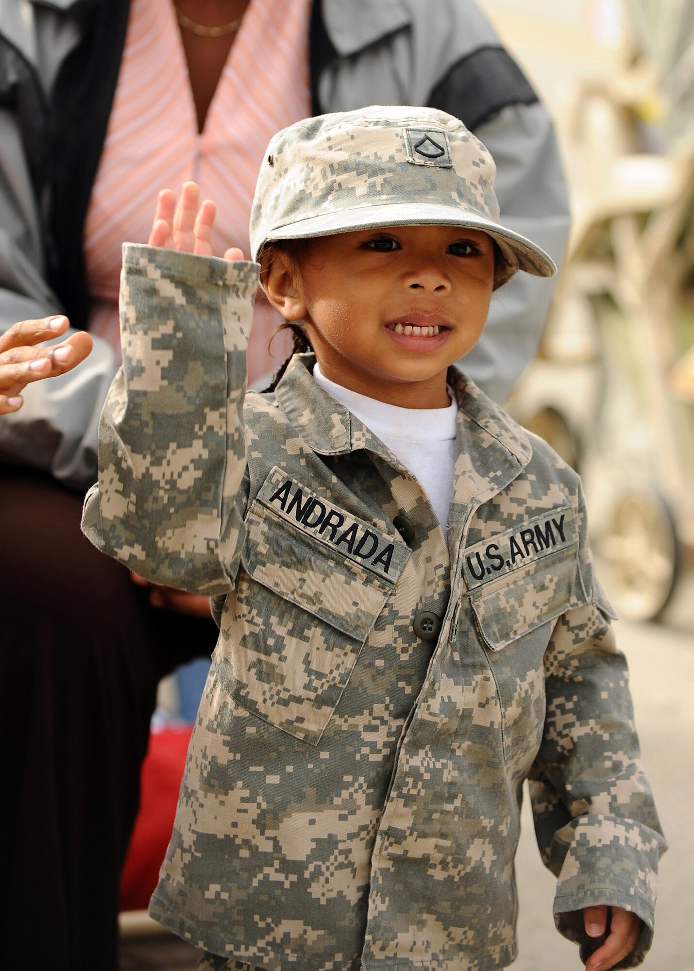 A young child waves to her father during the 1st Stryker Brigade Combat Team, 25th Infantry Divisions' deployment ceremony Sept. 10, 2008 at Fort Wainwright. The deployment ceremony included a pass-in-review portion where the families could view the whole brigade. (U.S. Air Force photo by Airman 1st Class Willard E. Grande II) 
