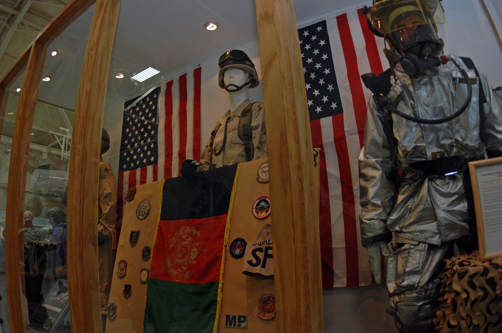The new Operations Enduring and Iraqi Freedom display was unveiled at the South Dakota Air and Space Museum Sept. 11. The display contains a fire fighter ensemble along with other uniforms and badges in honor of lost lives in the 9/11 tragedy. (U.S. Air Force photo by Airman Corey Hook)