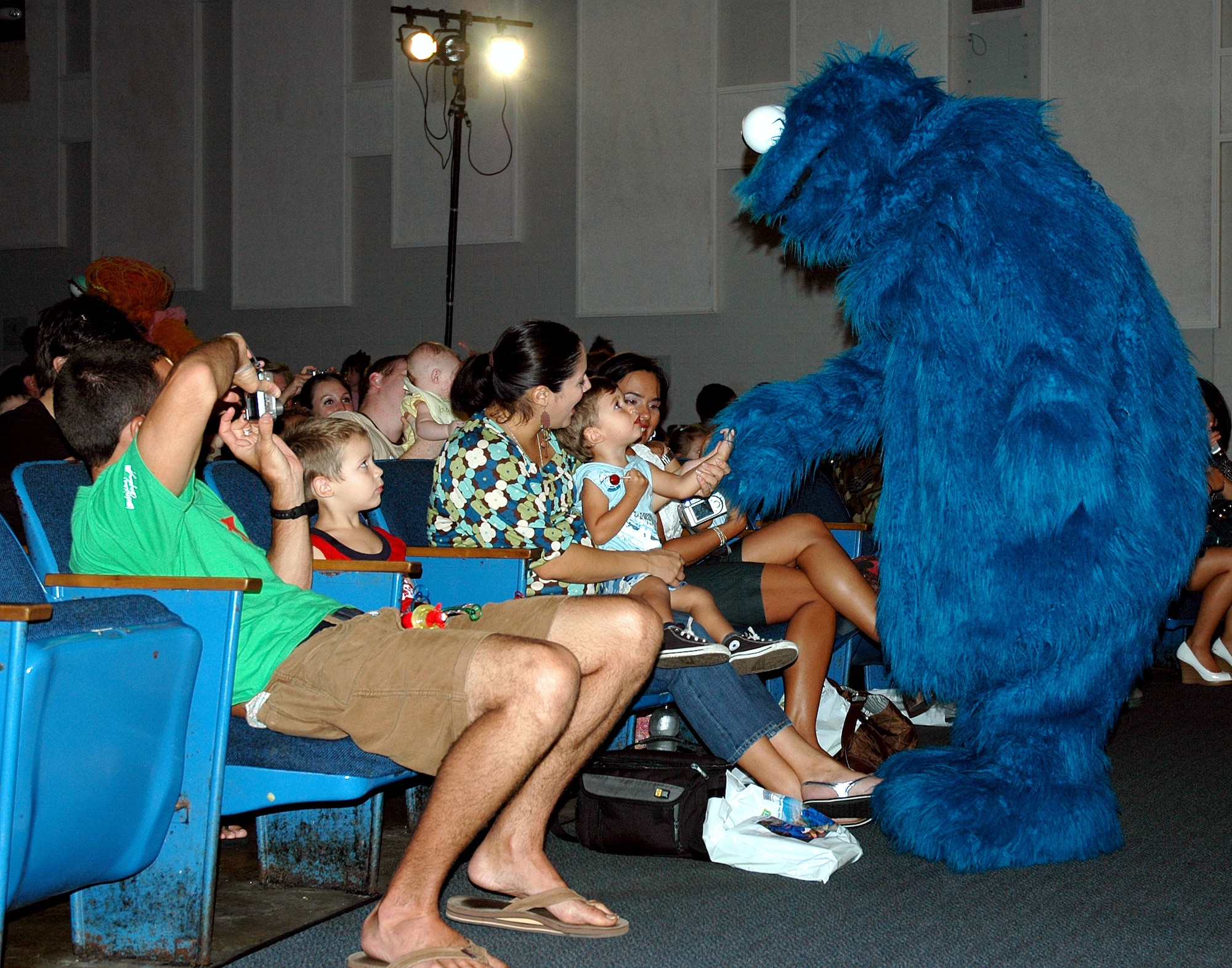EGLIN AIR FORCE BASE, Fla. -- Cookie Monster shakes hands with families during The Sesame Street Experience for Military Families tour at the base theater Sept 11. Sesame Workshop and the United Service Organizations partnered to bring the free 25-min show to more than 40 military installations across the United States as part of Sesame?s military outreach program Talk, Listen, Connect. (U.S. Air Force photo/Capt. Carrie L. Kessler)