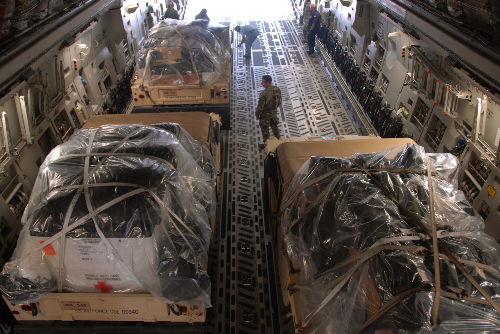Humvees and humanitarian supplies are loaded on a C-17 Globemaster III Sept. 10 at Kelly Field, Texas. Supplies were flown to McAllen, Texas, to help prepare for the arrival of Hurricane Ike. The C-17 is assigned to the 58th Airlift Squadron at Altus Air Force Base, Okla. (U.S. Air Force photo/Senior Airman Jennifer L. Flores) 
