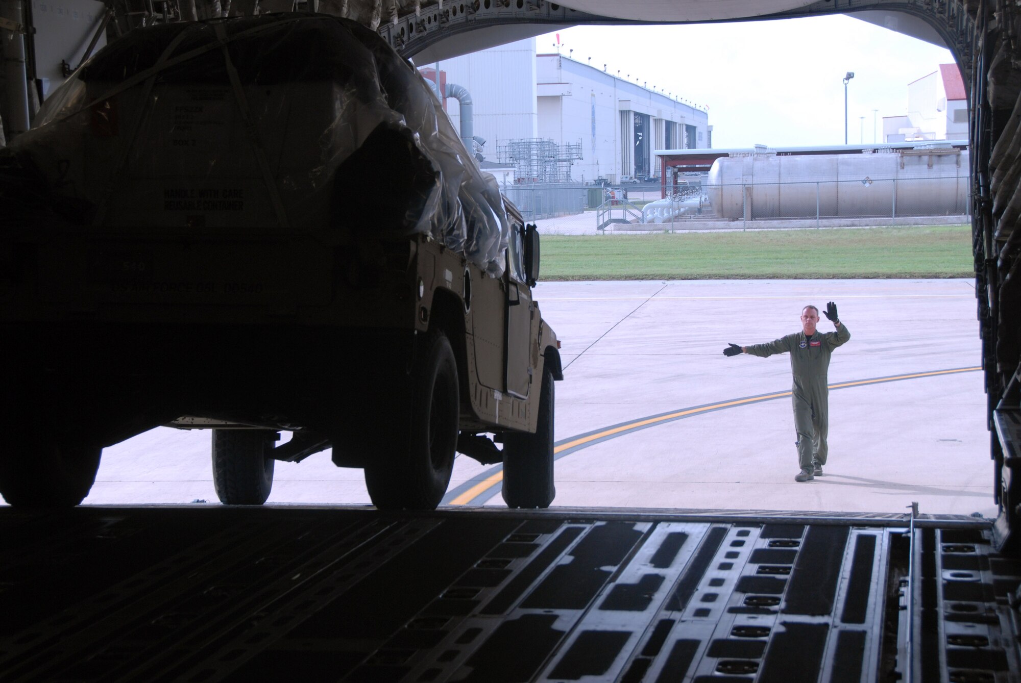 Staff Sgt. Jon Jackson directs a Humvee into a C-17 Globemaster III Sept. 10 at Kelly Field, Texas. Supplies were flown to McAllen, Texas, in support of Hurricane Ike preparation efforts. Sergeant Jackson is a loadmaster assigned to the 58th Airlift Squadron from Altus Air Force Base, Okla. (U.S. Air Force photo/Senior Airman Jennifer L. Flores) 
