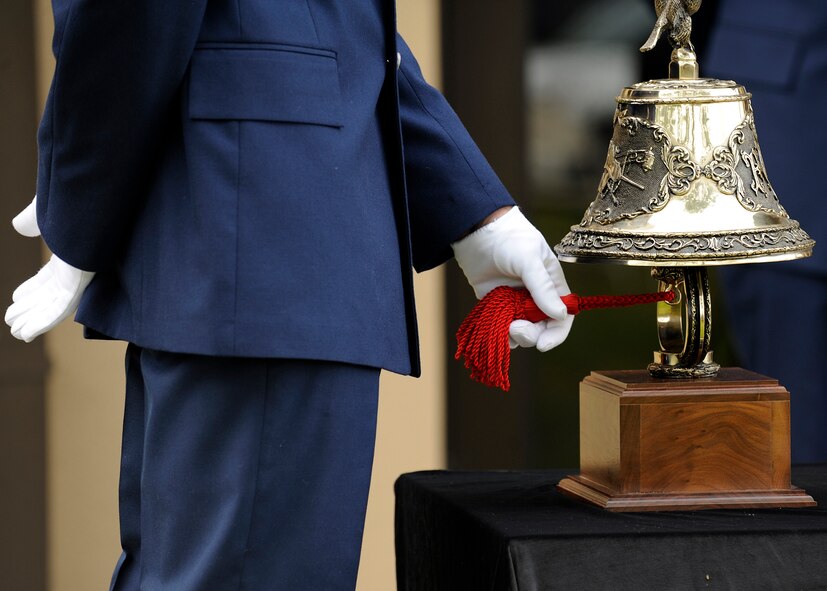 MOODY AIR FORCE BASE, Ga. -- Senior Airman Matthew Babbitt, 23rd Civil Engineer Squadron fire fighter, rings a bell in honor of those who lost their lives on September 11, 2001 during a memorial ceremony here Sep. 11. The ringing of the bell is a tradition to pay respect to those who gave their lives in the line of duty.  (U.S. Air Force photo by Senior Airman Brittany Barker)