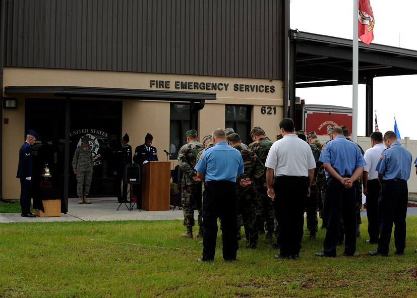 MOODY AIR FORCE BASE, Ga. -- Members of the 23rd Civil Engineer Squadron fire department bow their heads while observing a moment of silence during a September 11 memorial ceremony here Sep. 11. The ceremony was held in remembrance of those who lost their lives on September 11, 2001. (U.S. Air Force photo by Senior Airman Brittany Barker)
