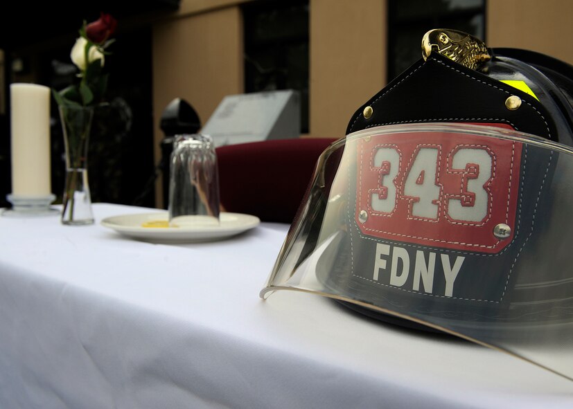 MOODY AIR FORCE BASE, Ga. -- A fallen fire fighter's table was displayed during a September 11 memorial ceremony held by the 23rd Civil Engineer fire department here Sep. 11. The table held roses, a candle, a plate with salt, a lemon and a fire fighter's helmet. (U.S. Air Force photo by Senior Airman Brittany Barker)