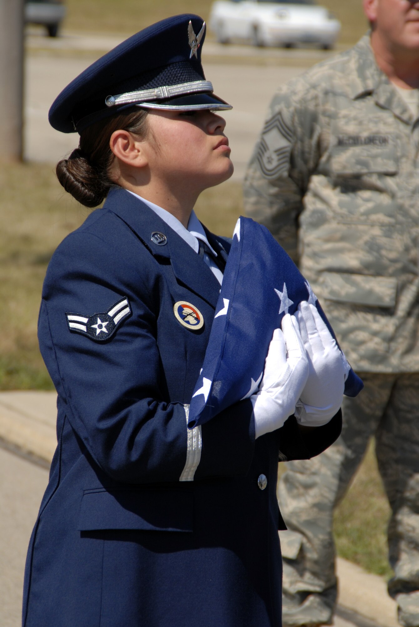WRIGHT-PATTERSON AFB, Ohio - Airman First Class Carmen Mena-Flores, a member of a joint forces Honor Guard team from the 445th Airlift Wing and Wright-Patterson AFB posts the colors during a Patriot Day Ceremony at the 445th Airlift Wing.  Wing members took a few moments to remember and honor the victims of September 11, 2001, and reaffirm their commitment to the Global War on Terror. (U.S. Air Force photo/Tech. Sgt. Charlie Miller)
