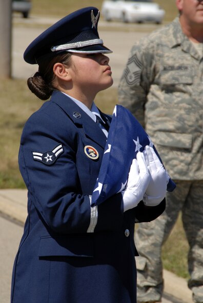 WRIGHT-PATTERSON AFB, Ohio - Airman First Class Carmen Mena-Flores, a member of a joint forces Honor Guard team from the 445th Airlift Wing and Wright-Patterson AFB posts the colors during a Patriot Day Ceremony at the 445th Airlift Wing.  Wing members took a few moments to remember and honor the victims of September 11, 2001, and reaffirm their commitment to the Global War on Terror. (U.S. Air Force photo/Tech. Sgt. Charlie Miller)
