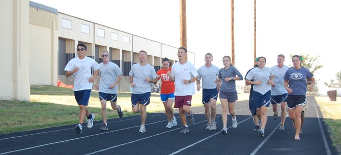 Members of Team Malmstrom who will be competing in the Air Force Marathon Sept. 20 at Wright-Patterson Air Force Base, Ohio, train together at the base track. Fifteen individuals have been training together for nine months in preparation for the race. (U.S. Air Force photo/Senior Airman Emerald Ralston)
