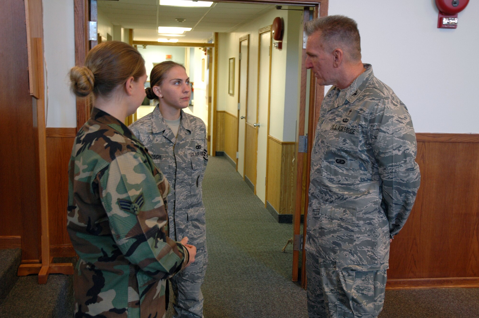 Chaplain (Col.) Gregory Tate, Air Force Space Command command chaplain, speaks with Senior Airman Crystal Levesque and Staff Sgt. Alicia Loesch, 341st Missile Security Forces Squadron members acting as chaplain assistant augmentees during a one-day visit to Malmstrom. (U.S. Air Force photo/Airman 1st Class Dillon White)