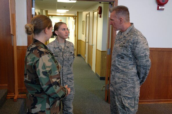 Chaplain (Col.) Gregory Tate, Air Force Space Command command chaplain, speaks with Senior Airman Crystal Levesque and Staff Sgt. Alicia Loesch, 341st Missile Security Forces Squadron members acting as chaplain assistant augmentees during a one-day visit to Malmstrom. (U.S. Air Force photo/Airman 1st Class Dillon White)