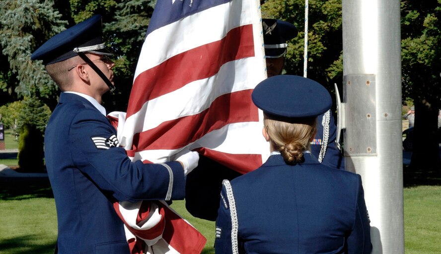 FAIRCHILD AIR FORCE BASE, Wash. – Three members of Fairchild’s Honor Guard lower the American flag during a Patriot’s Day Retreat here Sept. 11. After lowering the flag, the Honor Guard members folded it and presented it to Col. Thomas Sharpy, 92nd Air Refueling Wing commander, during the formal commemoration of the men and women who died in the Sept. 11, 2001, terrorist attacks. Since that day seven years ago, 1.3 million people have served in the United States military in support of the Global War on Terrorism. (U.S. Air Force photo / Staff Sgt. JT May III)