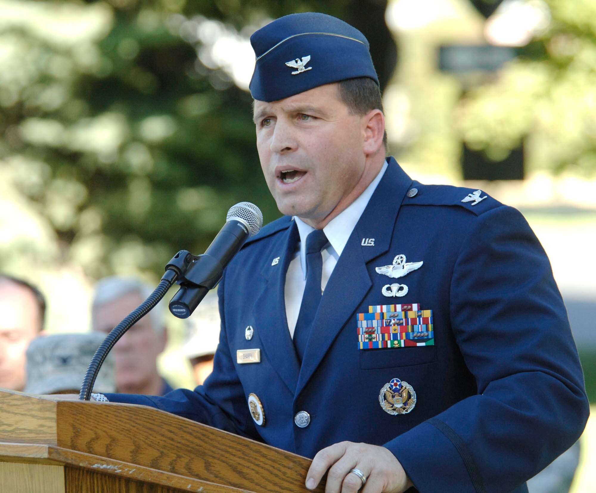 FAIRCHILD AIR FORCE BASE, Wash. – Col. Thomas Sharpy, 92nd Air Refueling Wing commander, speaks to a crowd of almost 1,000 Airmen and guests during a Patriot’s Day Retreat here Sept. 11. The ceremony was held in honor of the men and women who died in the terrorist attacks of Sept. 11, 2001, seven years ago. The colonel, who was serving at the White House in Washington D.C., as Senior Military Aide to the Vice President of the United States during the attacks, thanked attending Airmen for their service to the United States and the Global War on Terrorism. (U.S. Air Force photo / Staff Sgt. JT May III)