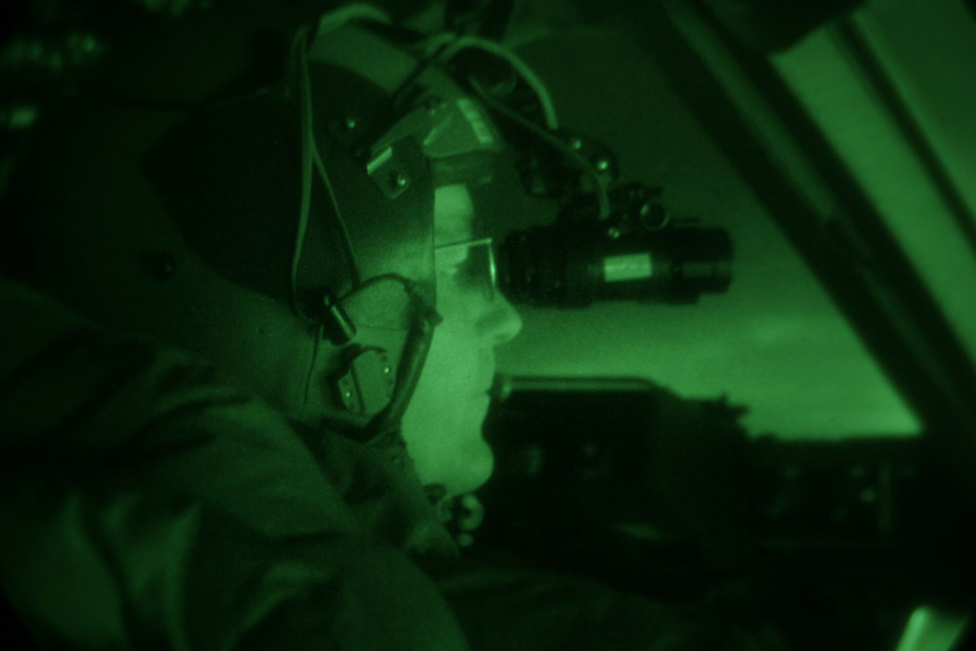 Lt. Col. Robert Weichert looks out over the ice after a night vision-assisted landing on Pegasus Ice Runway near McMurdo Station, Antarctica, on Sept. 11. Colonel Weichert is part of a crew testing the concept of of using night vision technology in combination with reflective cones and limited electrical lighting to land safely on the ice runway after dark. The mission was conducted by Joint Task Force Support Forces Antarctica, headquartered at Hickam Air Force Base, Hawaii, and led by 13th Air Force. The joint task force is currently conducting Operation Deep Freeze in support of the National Science Foundation and U.S. Antarctic Program. Colonel Weichert is a C-17 evaluator pilot with the 313th Airlift Squadron at McChord AFB, Wash. (U.S. Air Force photo/Master Sgt. Chris Vadnais)