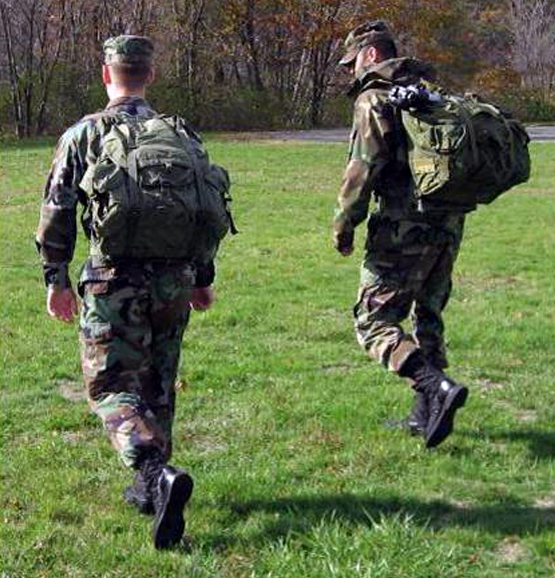 Two Airmen from the Electronic Systems Center of Hanscom Air Force Base, Mass., carry a portable contingency landing system in backpacks during Air Mobility Battlelab's Portable Contingency Landing System Initiative concept demonstration at Duke Field, Fla., in July 2008.  The initiative calls for a CLS that can bridge the gap between current precision landing systems and a future, fully-automated, on-board autonomous landing capability for military aircraft landing in remote airfields.  The portability factor helps contingency response forces who set up the contingency landing system.  (U.S. Air Force Photo)