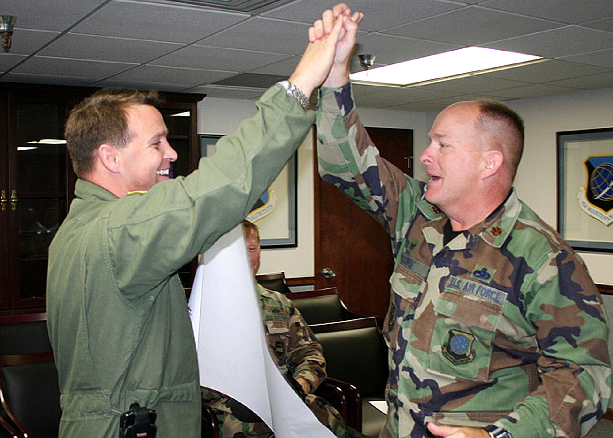 FAIRCHILD AIR FORCE BASE, Wash. – Col. Thomas Sharpy, 92nd Air Refueling Wing commander, throws Maj. Robert Moore, 92nd Aircraft Maintenance Squadron commander, a high five to congratulate him on his son’s second place finish in Air Mobility Command’s MATCH-UP 2008 game Sept. 8. The major’s son, Austin, won $7,000. (U.S. Air Force photo / Airman 1st Class Joshua Chapman)