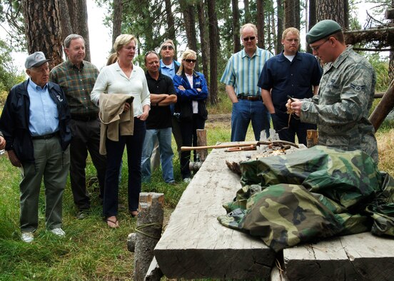 FAIRCHILD AIR FORCE BASE, Wash. – Airman 1st Class David Jones, 22nd Training Squadron Survival, Evasion, Rescue and Escape specialist, demonstrates to Fairchild’s Honorary Commanders how to use your surroundings to start a fire on the “back 40”  here Sept. 5. An assortment of wood, plastic spoons, lint and brush were used in the demonstration. (U.S. Air Force photo / Airman 1st Class Melissa Barnett)