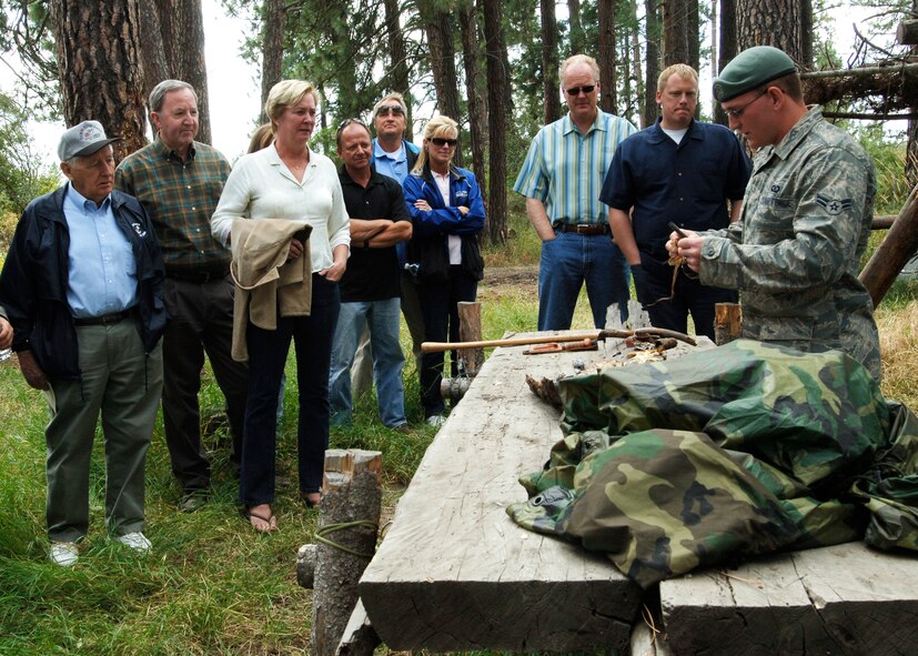 FAIRCHILD AIR FORCE BASE, Wash. – Airman 1st Class David Jones, 22nd Training Squadron Survival, Evasion, Rescue and Escape specialist, demonstrates to Fairchild’s Honorary Commanders how to use your surroundings to start a fire on the “back 40”  here Sept. 5. An assortment of wood, plastic spoons, lint and brush were used in the demonstration. (U.S. Air Force photo / Airman 1st Class Melissa Barnett)