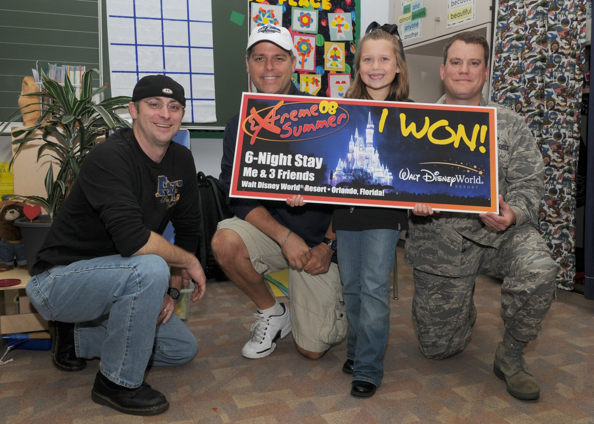 SPANGDAHLEM AIR BASE, Germany -- From left: Andrew Rice, coordinator for Extreme Summer, John Olson, marketing director, Kelsey Garcia, youth category grand prize winner, and Maj. Michael Wyatt, 52nd Force Support Squadron commander, display Kelsey's prize, an all-expense six night trip to Disney World for four, at Bitburg Air Base Sept. 12, 2008. (U.S. Air Force photo by Staff Sgt. Heather M. Norris)