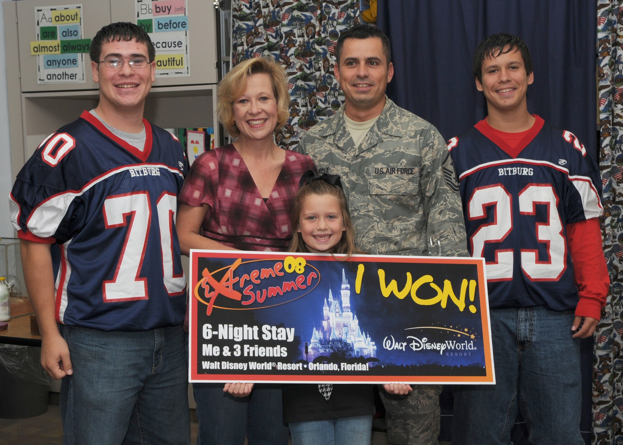 SPANGDAHLEM AIR BASE, Germany -- Master Sgt. Michael Garcia, 606th Air Control Squadron first sergeant, and his family pose with daughter Kelsey Garcia, as she won an all-expense six night trip to Disney World for four by particpating in Extreme Summer.  Kelsey is one of the youth category grand prize winners. (U.S. Air Force photo by Staff Sgt. Heather M. Norris) 