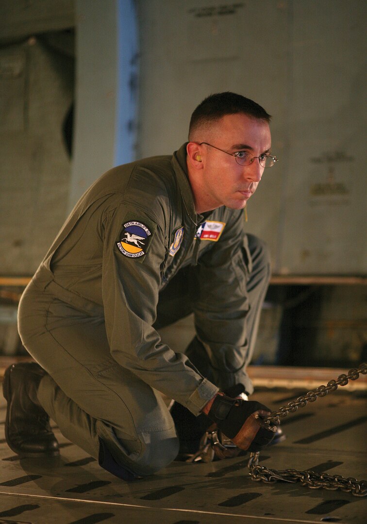 9/12/2008 - Master Sgt. John Wells secures a tie down attached to a vehicle on a C-5 aircraft before take-off. Sergeant Wells is a loadmaster with the 433rd Airlift Wing, 356th Airlift Squadron at Lackland Air Force Base, Texas. (USAF photo by Robbin Cresswell)