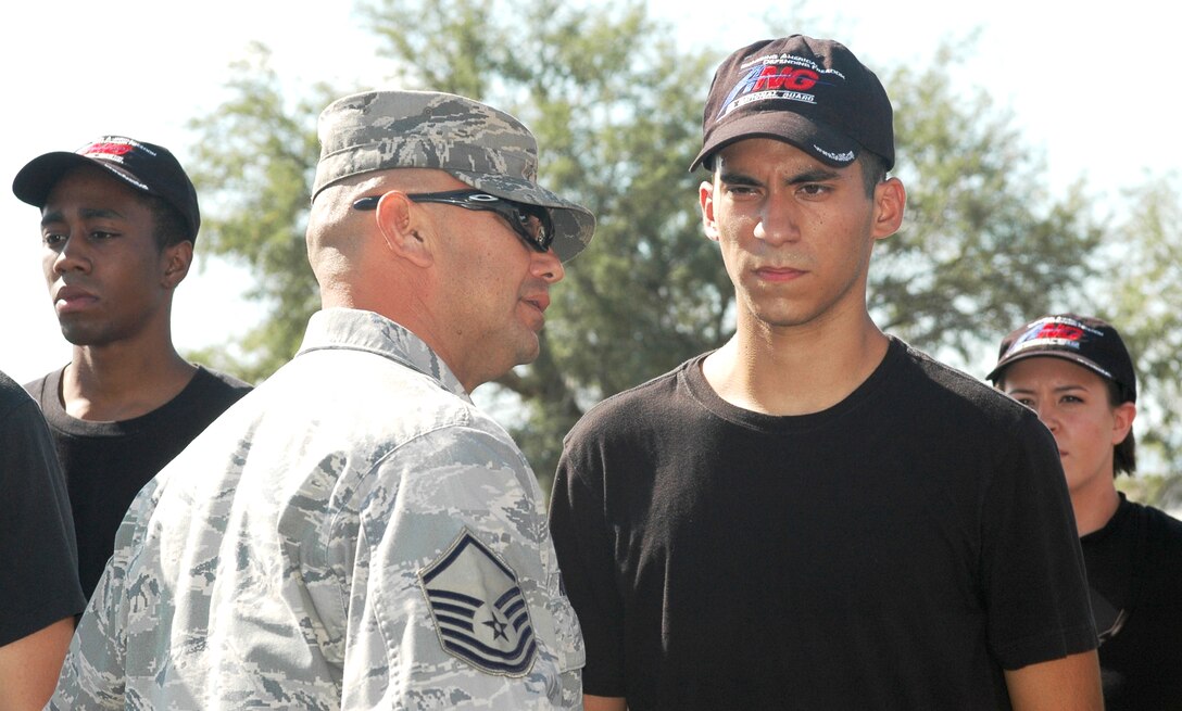 Master Sgt. Gilbert Alcaraz, a former Military Training Instructor, inspects Airman First Class Aaron Clavero for a close shave during a student flight formation. Intense preparation here at the 162nd Fighter Wing prepares recruits for the rigors of basic training and technical school. (Air National Guard photo by Staff Sgt. Deiree Twombly)