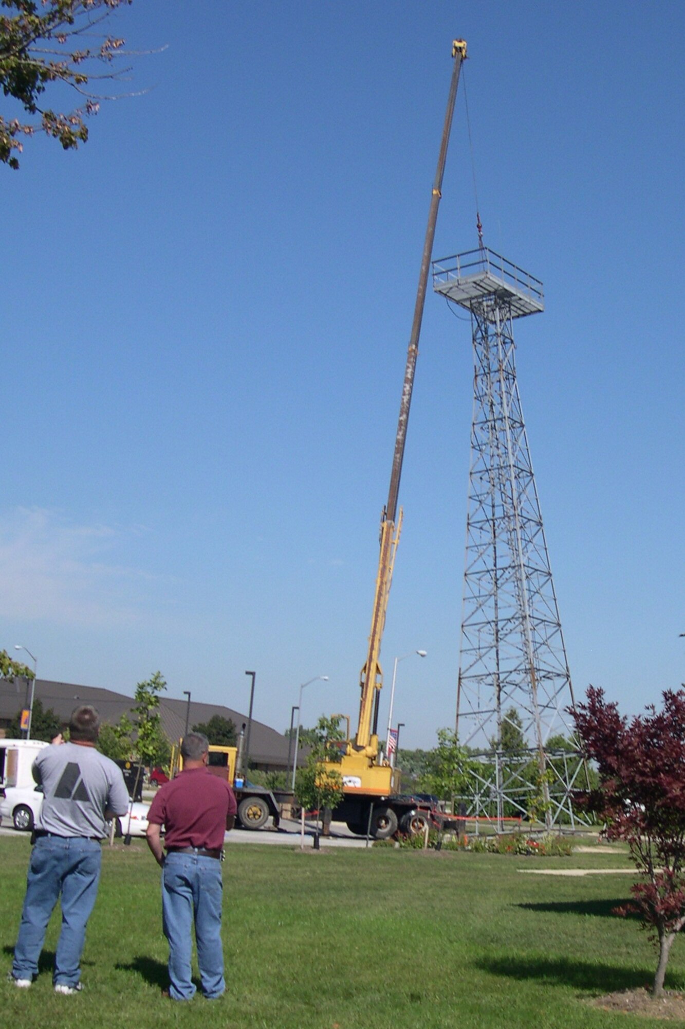 GRISSOM AIR RESERVE BASE, Ind., -- 434th Communications Squadron members watch as the old tower in front of their building is slowly taken down. The tower had been a fixture in front of Bldg. 427 for many years, but was no longer in service. (U.S. Air Force photo/Master Sgt. Rob Hoffman)