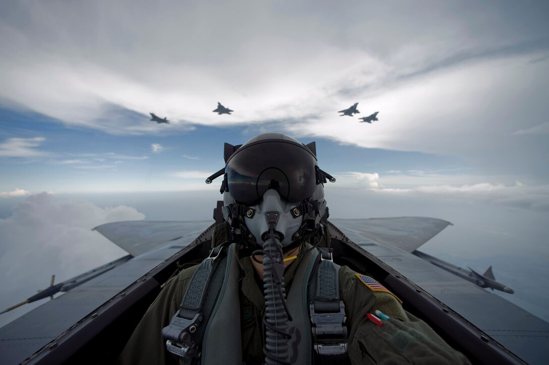 Aerial combat photographer, Staff Sgt. James L. Harper Jr., takes a self portrait Aug. 27 during a sortie over New Orleans with F-15 Eagles from the Louisiana Air National Guard and F-22 Raptors from Langley Air Force Base, Va. (U.S. Air Force photo/Staff Sgt. James L. Harper Jr.)
