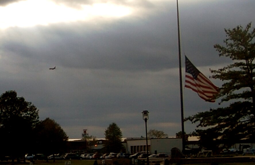 At the base flag pole on McGuire Air Force Base, N.J., the American flag flies at half-mast Sept. 11, 2008, in honor of the nearly 3,000 victims of Sept. 11, 2001.  In the distance a KC-10 Extender can be seen flying over the base.  (U.S. Air Force Photo/Tech. Sgt. Scott T. Sturkol)