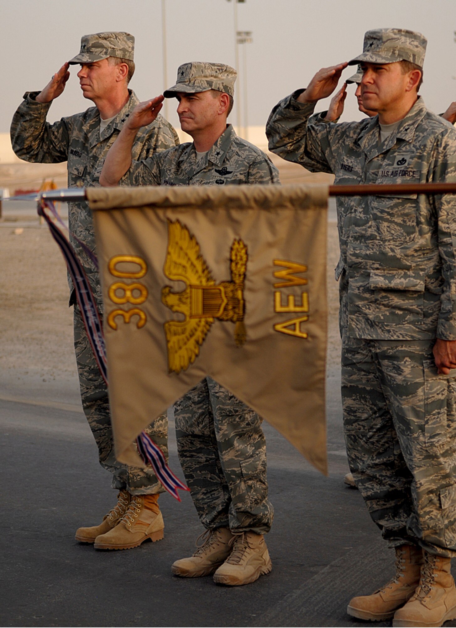 SOUTHWEST ASIA -- (left to right) Maj. Gen. Del Eulberg, Air Force Civil Engineer commander; Brig. Gen. H.D. Polumbo, Jr., 380th AEW commander; and Brig. Gen. Tim Byers, Air Combat Command; salute during the National Anthem at the Patriot Day ceremony here. (U.S. Air Force photo/Tech. Sgt. Denise Johnson)(released)