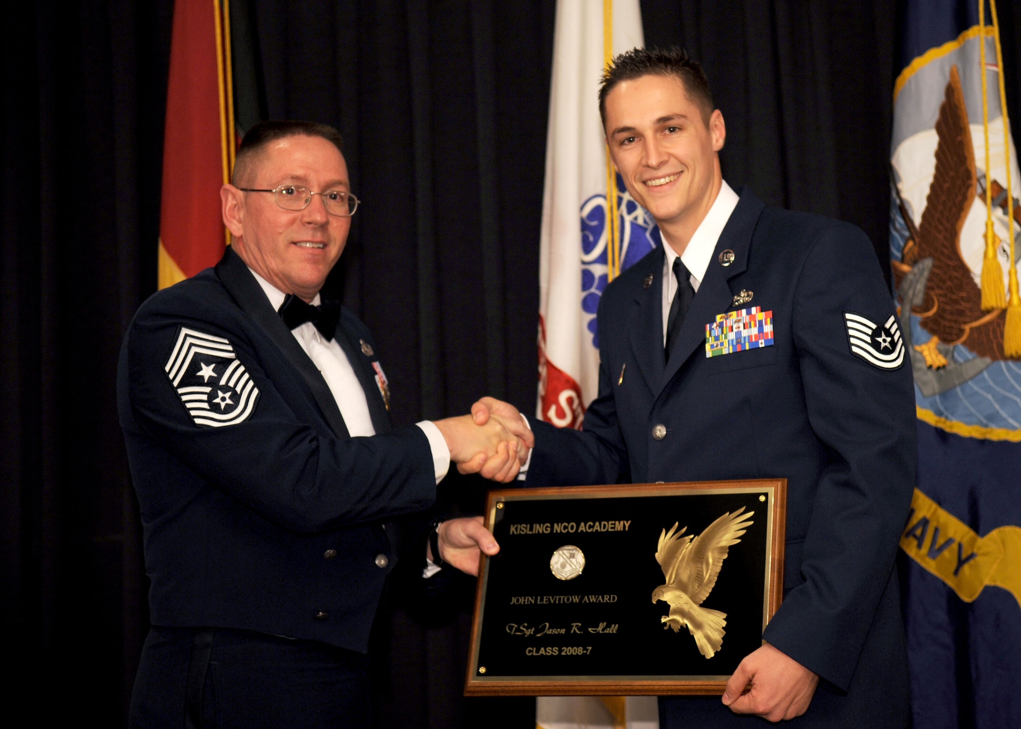RAMSTEIN AIR BASE, Germany -- Tech. Sgt.  Jason Hall, 52nd Equipment Maintenance Squadron, receives the John L. Levitow Honor Graduate Award at the Non-Commissioned Officer Academy Graduation Sept. 11, 2008. The Levitow Award is the highest honor awarded in the Professional Military Education. (U.S. Air Force photo by Senior Airman Levi Riendeau)