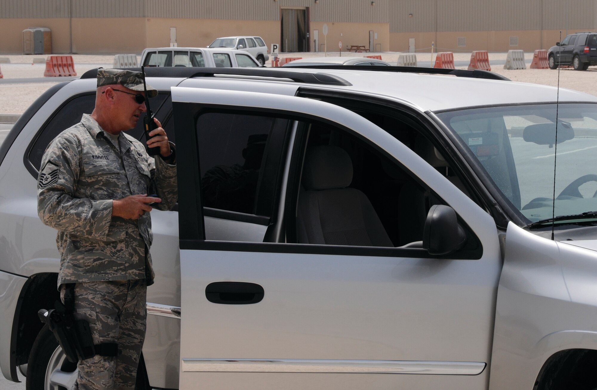 Master Sgt. Doug Kimmell, 379th Expeditionary Security Forces Squadron, Det. 1, calls in a driver's information during a traffic stop while maintaining a safe defensive position Sept. 8, 2008.  Detachment members, like Sergeant Kimmell, had to use Army procedures while performing the “in lieu of” tasking. Sergeant Kimmell is deployed from Stratton Air National Guard Base, Schenectady, N.Y., in support of Operations Iraqi and Enduring Freedom and Joint Task Force-Horn of Africa.  (U.S. Air Force photo by Tech. Sgt. Michael Boquette) 