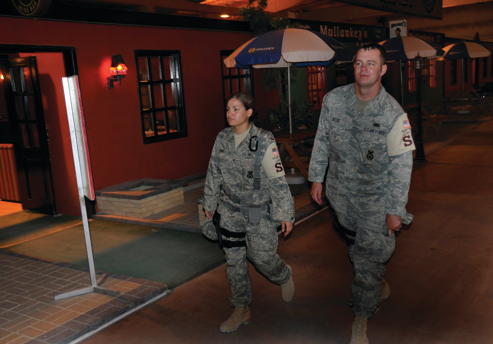 Senior Airmen Sarah Parks and Thomas Beers, 379th Expeditionary Security Forces Squadron, Det. 1, execute a foot patrol through a Morale, Welfare and Recreation facility Sept. 8.  Airman Parks is a native of Edmond, Okla., deployed from Wright-Patterson Air Force Base, Ohio, and Airman Beers hails from Palm Bay, Fla., deployed from Davis-Monthan AFB, Ariz. 