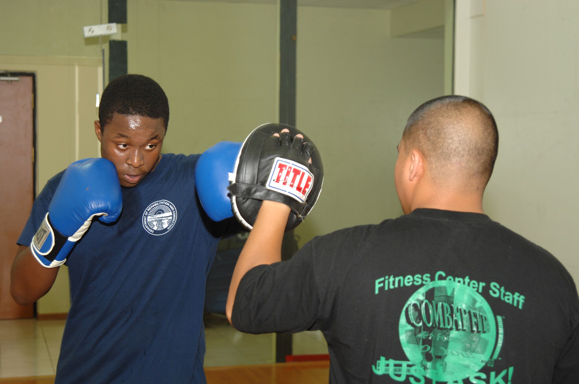 Airman 1st Class Randy Reyes, 39th Force Support Squadron fitness specialist, teaches Nate Eaddie basic boxing skills Aug. 20. Mr. Eaddie is one of Airman Reyes’ students in the new boxing class held every Tuesday and Thursday at the fitness center. (U.S. Air Force photo by Senior Airman Benjamin Wilson)