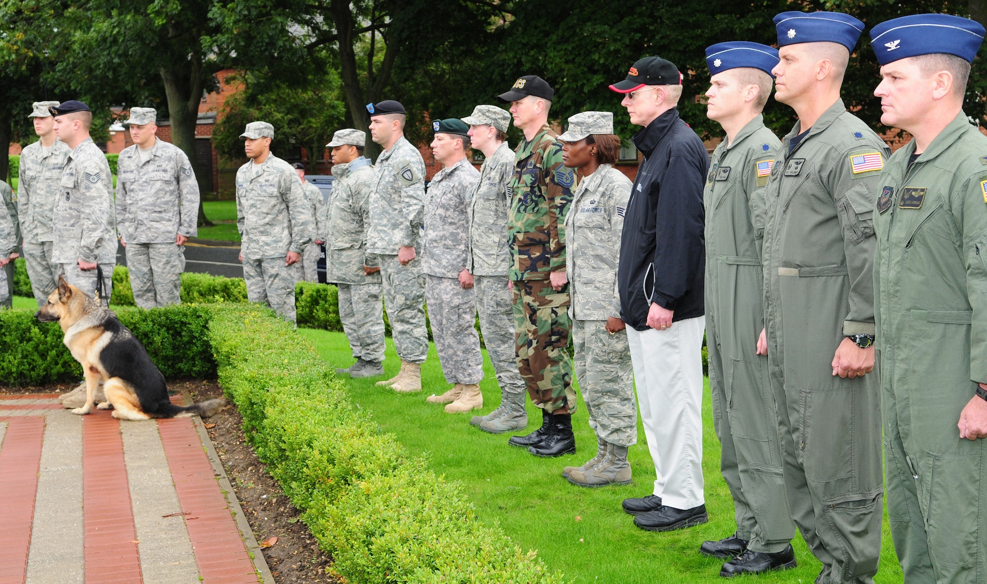 Team Mildenhall members stand at attention as Chaplain Hodges Viccellio, 100th Air Refueling Wing chaplain, reads his thoughts and memories of Sept. 11 during a memorial service at RAF Mildenhall, England Sept. 11, 2008. (U.S. Air Force photo by Karen Abeyasekere)