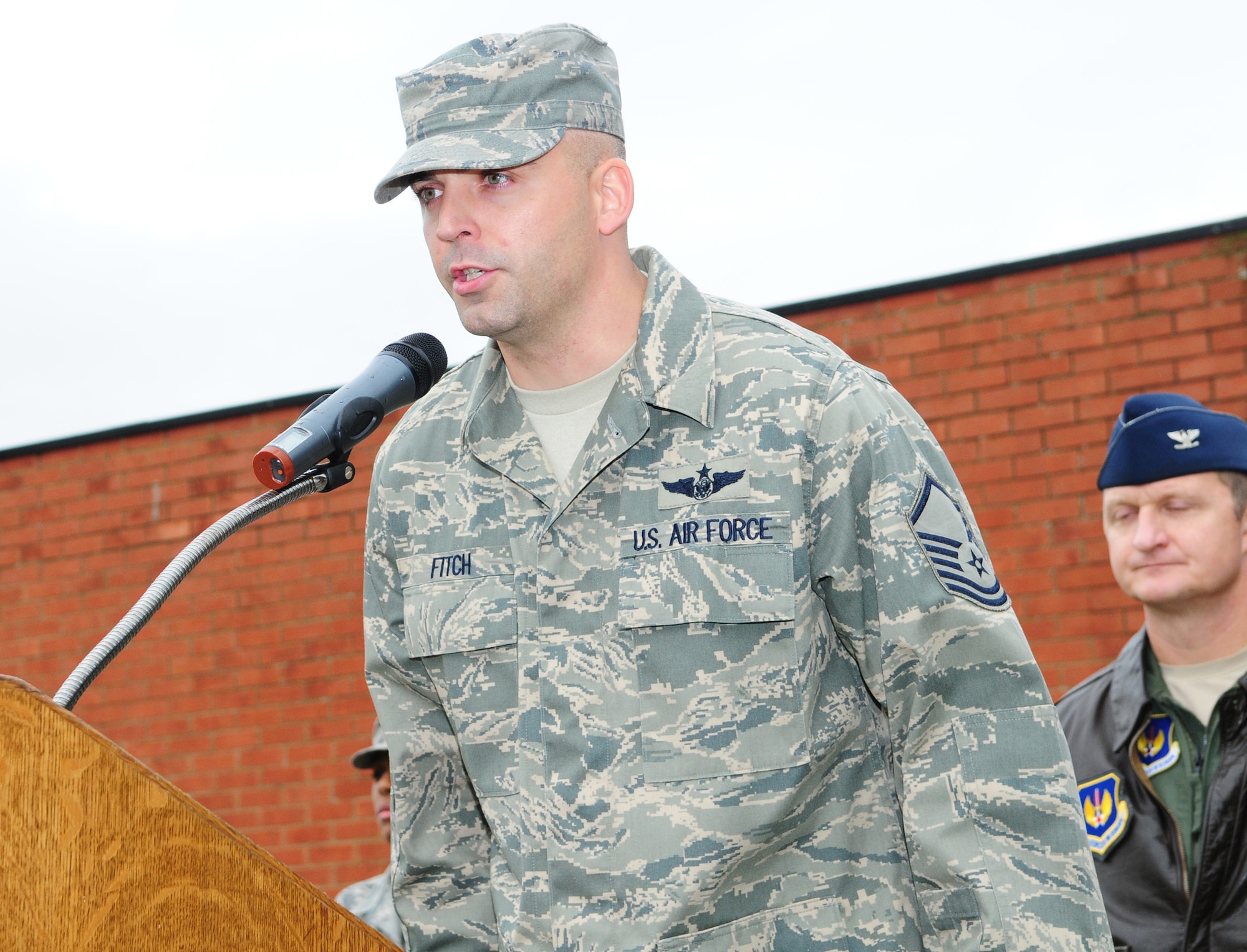 Master Sgt. Bill Fitch, 351st Air Refueling Squadron, reads part of the Airman's Creed at the start of the Sept. 11 memorial service at RAF Mildenhall. Four Airmen, ranging in rank from airman first class to colonel, read part of the Airman's Creed after the colors were posted at the ceremony. (U.S. Air Force photo by Karen Abeyasekere)
