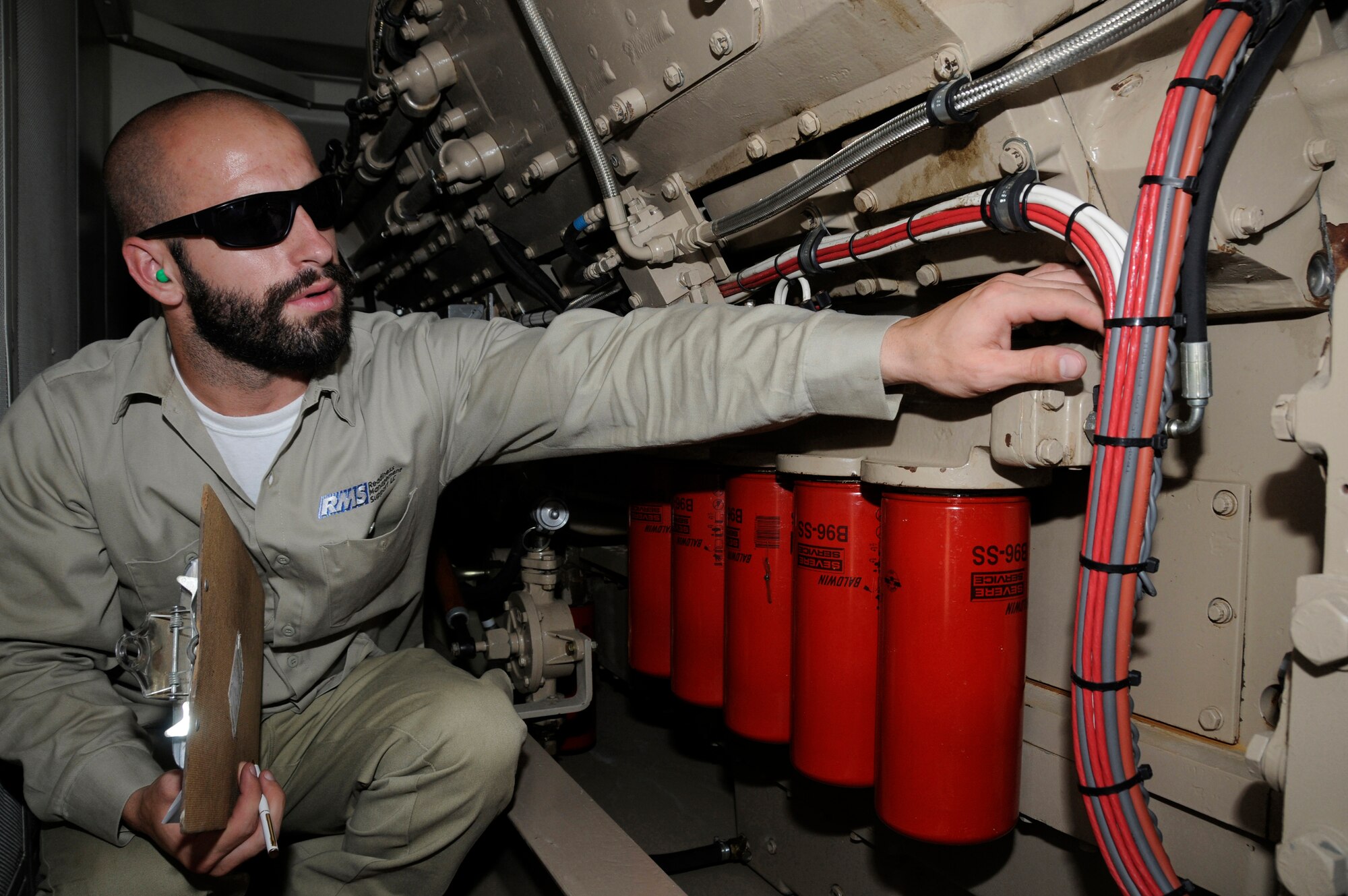 Mr. Daniel Dan, generator technician working for Readiness Management Support, performs a preventive maintenance inspection on a generator Sept. 11, 2008, at an undisclosed air base in Southwest Asia. Mr. Dan works in one of the four power plants containing 26 generators which produce power for all the facilities here. Mr. Dan, a native of Huntington Beach, Calif., is supporting Operations Iraqi Freedom, Enduring Freedom and Joint Task Force-Horn of Africa. (U.S. Air Force photo by Staff Sgt. Darnell T. Cannady/Released)