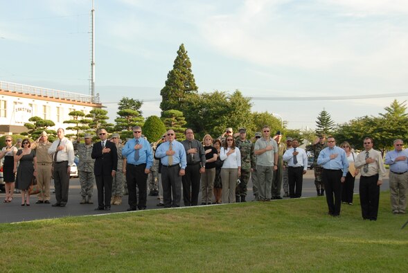 MISAWA AIR BASE, Japan -- Civilian residents pay their respects during a 9/11 Retreat Ceremony Sept. 11, 2008.  This year marked the seventh anniversary of the 9/11 terrorist attacks.  (U.S. Air Force photo by Senior Airman Laura R. McFarlane) 