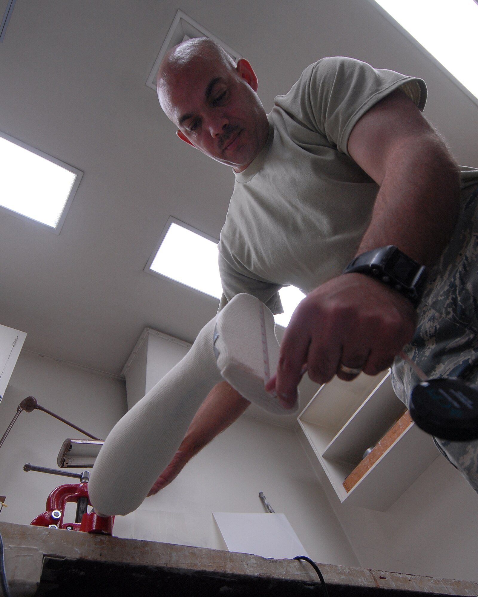 YOKOTA AIR BASE, Japan -- Technical Sergeant Sean McClintock measures a cost mold so he can create a brace for a patentient here, in the Orthotic Lab, on 10 Septeber. This shop services not on Yokota but other local sister service bases. (U.S. Air Force photo by Senior Airman Laszlo Babocsi)(Released)