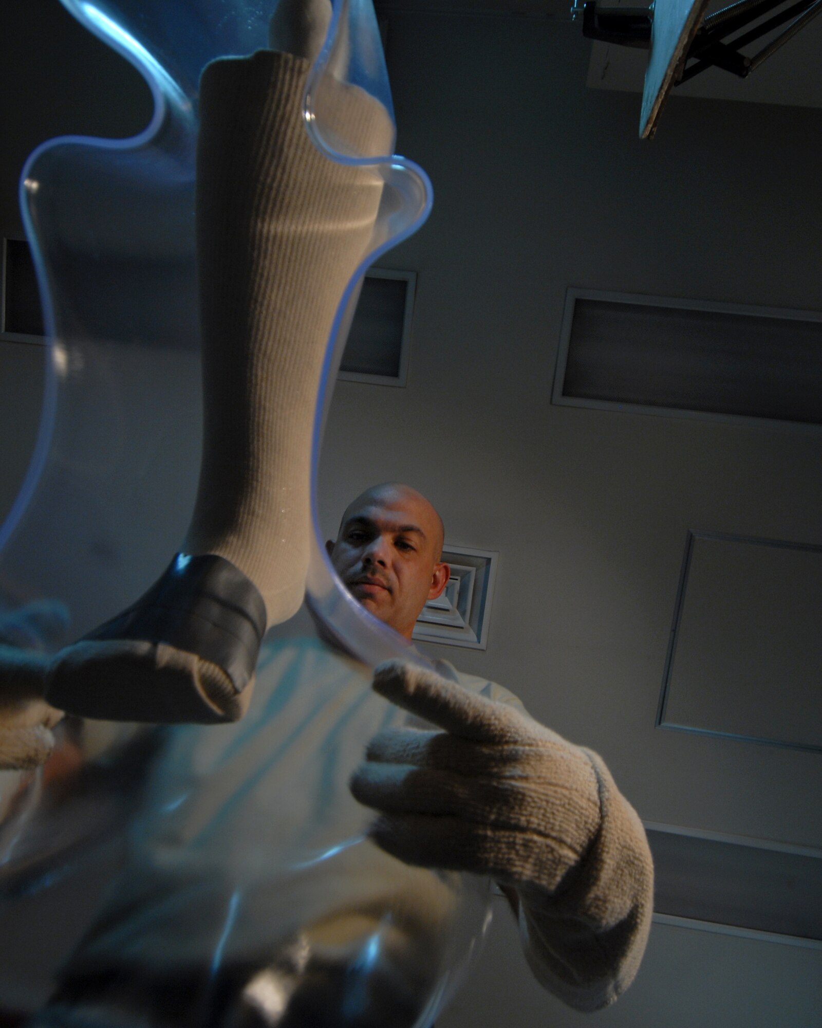 YOKOTA AIR BASE, Japan -- Technical Sergeant Sean McClintock places heated plastic on a cast molding, in the Orthotic Lab, on 10 Septeber. This just one step in the process of creating a brace t, that he makes for his patients. (U.S. Air Force photo by Senior Airman Laszlo Babocsi)(Released)