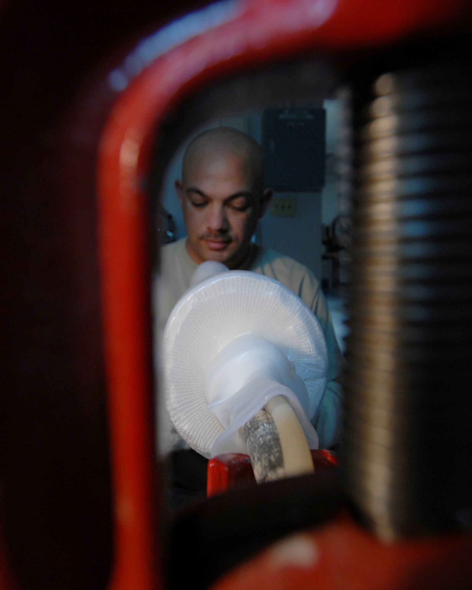 YOKOTA AIR BASE, Japan -- Technical Sergeant Sean McClintock smooths out heated plastic around a cast molding, in the Orthotic Lab, on 10 Septeber. This just one step in the process of creating a brace that he makes for his patients. (U.S. Air Force photo by Senior Airman Laszlo Babocsi)(Released)